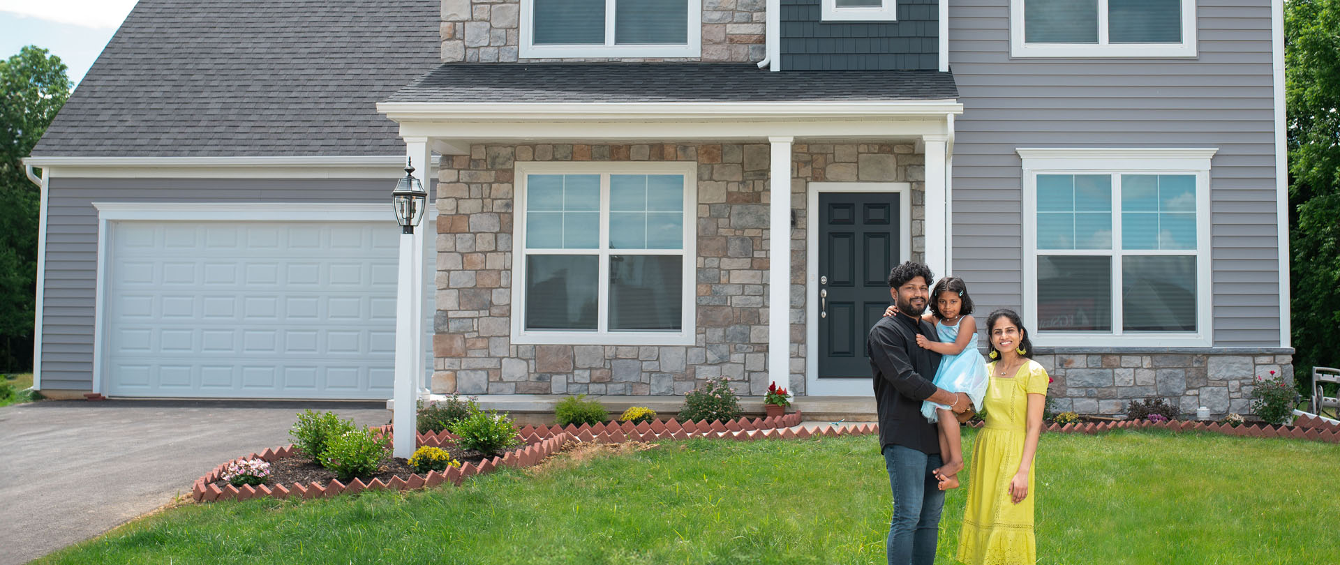 Happy Couple Holding a Sold Sign