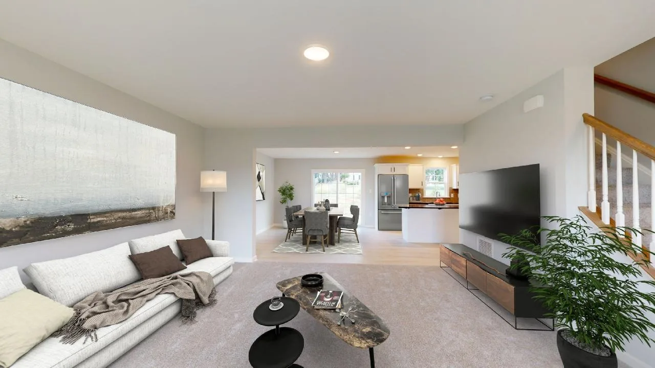 Modern living room with a white sofa, large abstract painting, and a flat-screen TV. An open layout leads to a dining area and kitchen. Light walls, carpet flooring, and a potted plant complete the cozy, bright space.