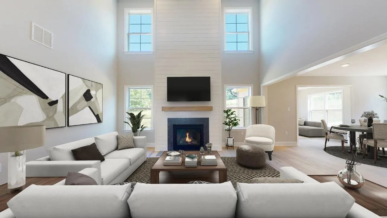 Spacious, modern living room with high ceilings, neutral-toned furniture, a fireplace with a TV above it, large windows, abstract wall art, and a view into a dining area.